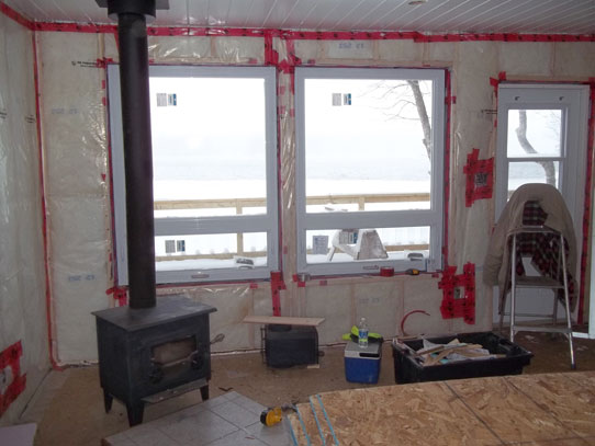 Install new windows and wall and roof insulation in cottage