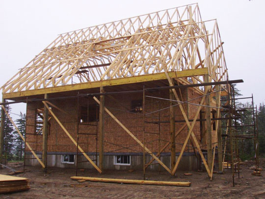 Basement and walls framed, roof truses installed on new beachfront hom.e