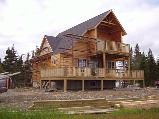 Exterior wood siding with clear stain installed. Wrap around decks almost complete on beachfront home built by Mark Oickle Construction.