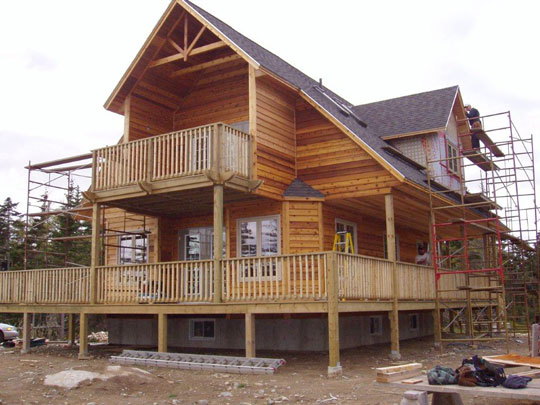 Second floor dormer window being installed on beachfront home, built by Mark Oickle Construction.