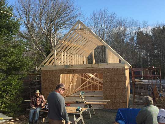 Installing roof trusses, and end walls on new garage. 