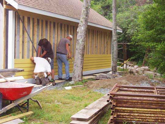 Building a roof and wall over an existing Quonset hut.
