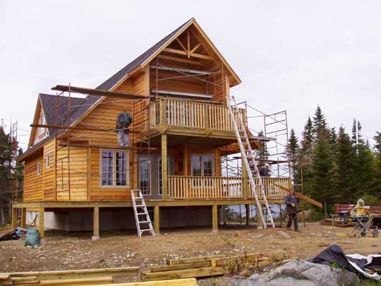 Mark Oickle's crew at work insralling wood siding on a new beach front home.