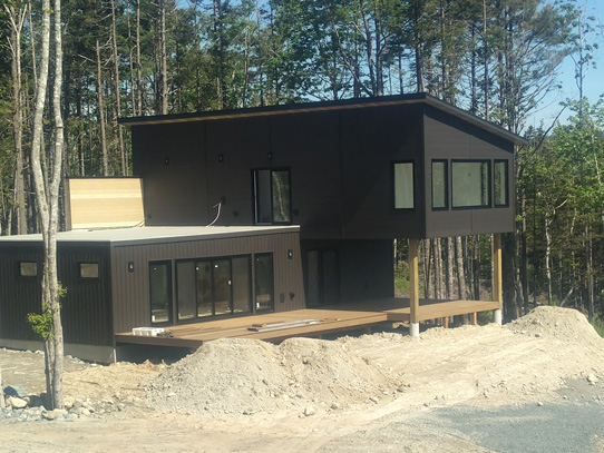 Modern brown clad house, two stories with deck