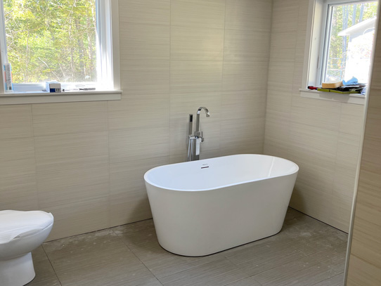 New bathroom with large soaker tub and two windows