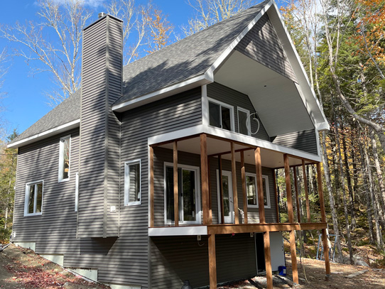 Both floors have sliding doors to access decks facing the lake front