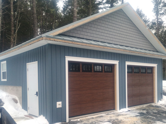 Blue two door garage built into the bank
