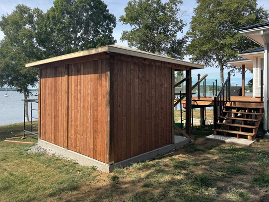 Free standing hot tub enclosure by deck